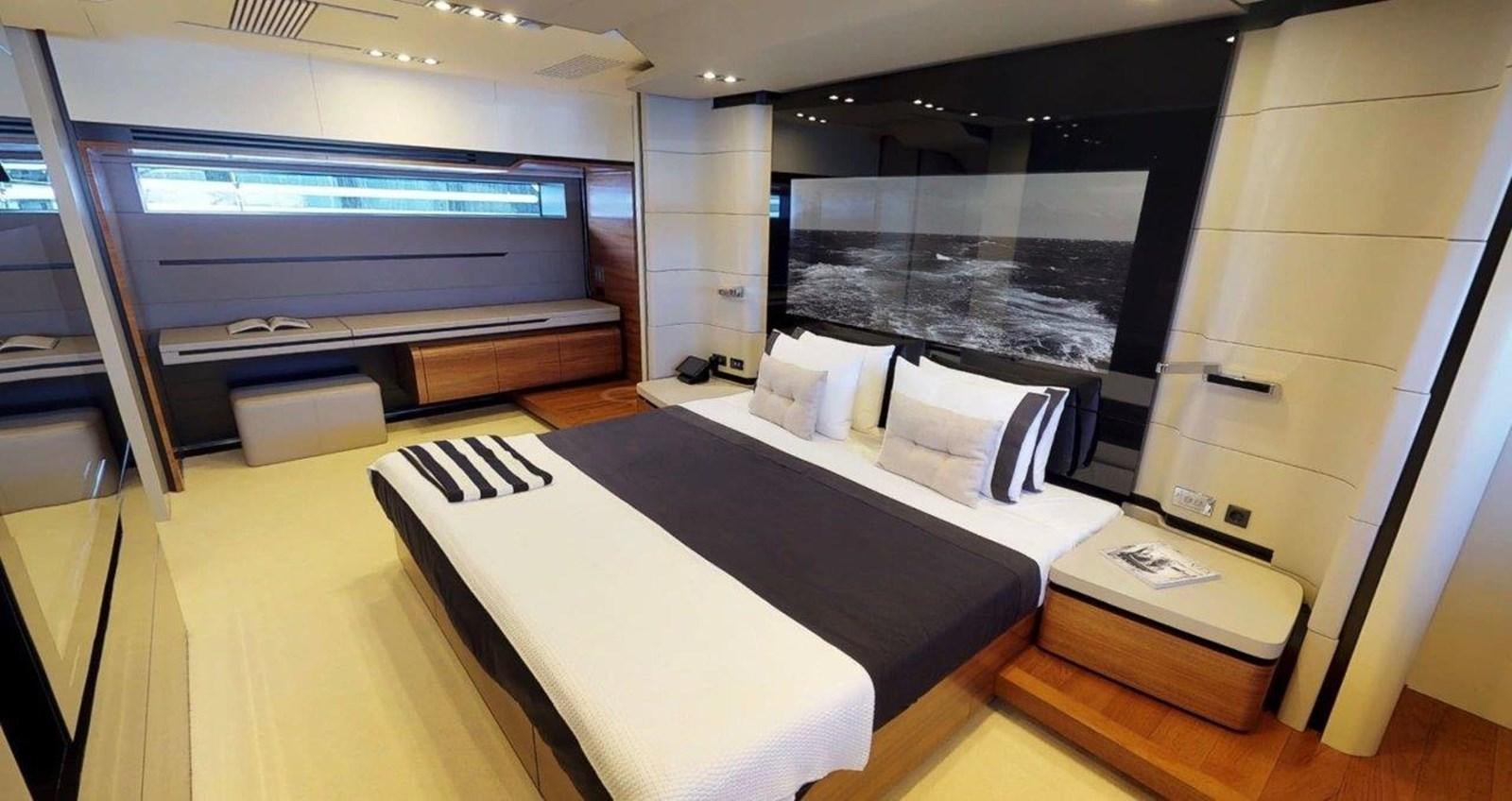 a room with a bed and a tv aboard FUSION Yacht for Sale