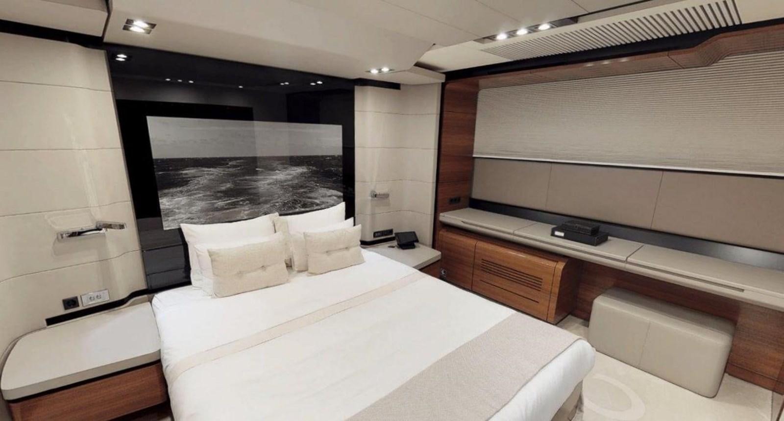 a room with a bed and a desk aboard FUSION Yacht for Charter