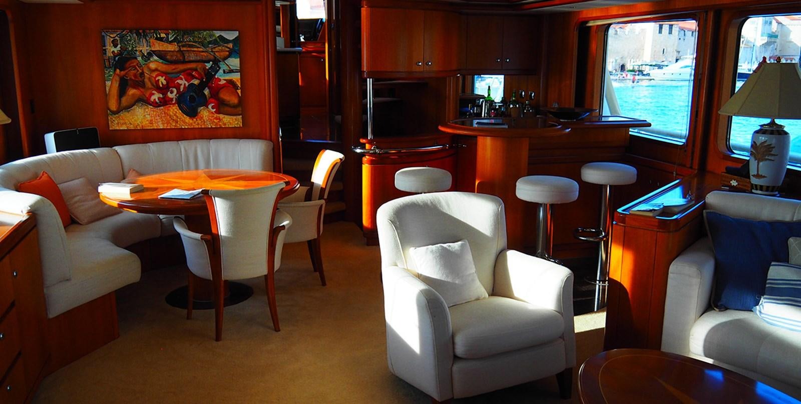a room with a table chairs and a couch aboard BLUE PEARL Yacht for Sale