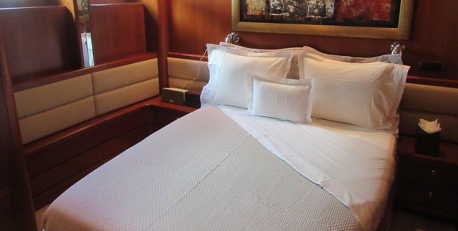 a bed with white sheets aboard BLUE PEARL Yacht for Sale