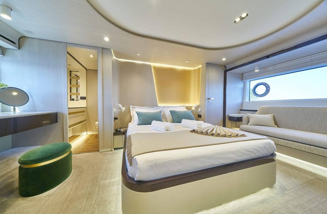 a room with a bed and a chair aboard VIVA Yacht for Sale