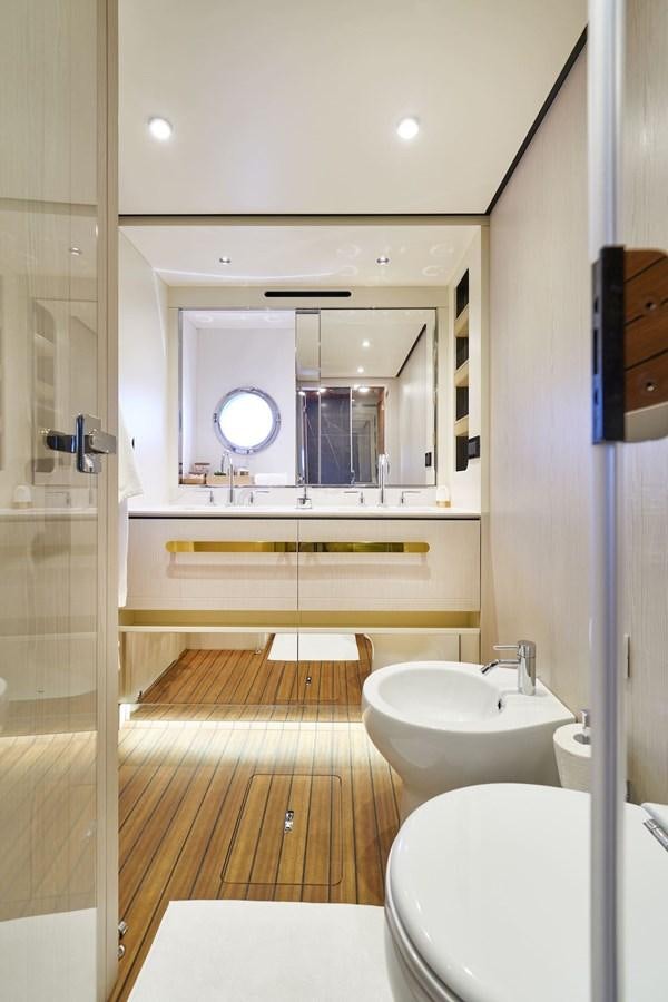 a bathroom with a large mirror aboard VIVA Yacht for Sale