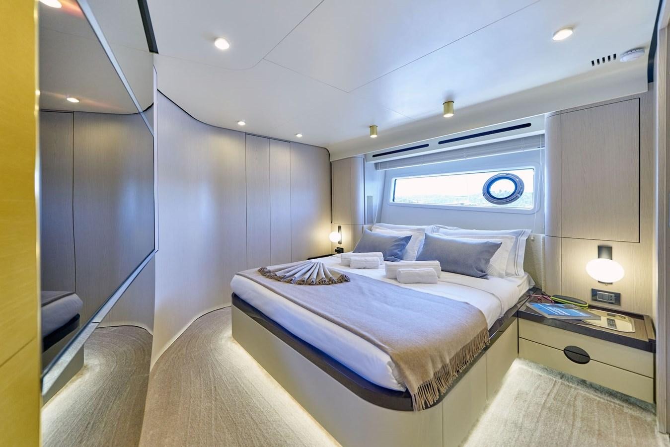 a bedroom with a bed and a large window aboard VIVA Yacht for Sale