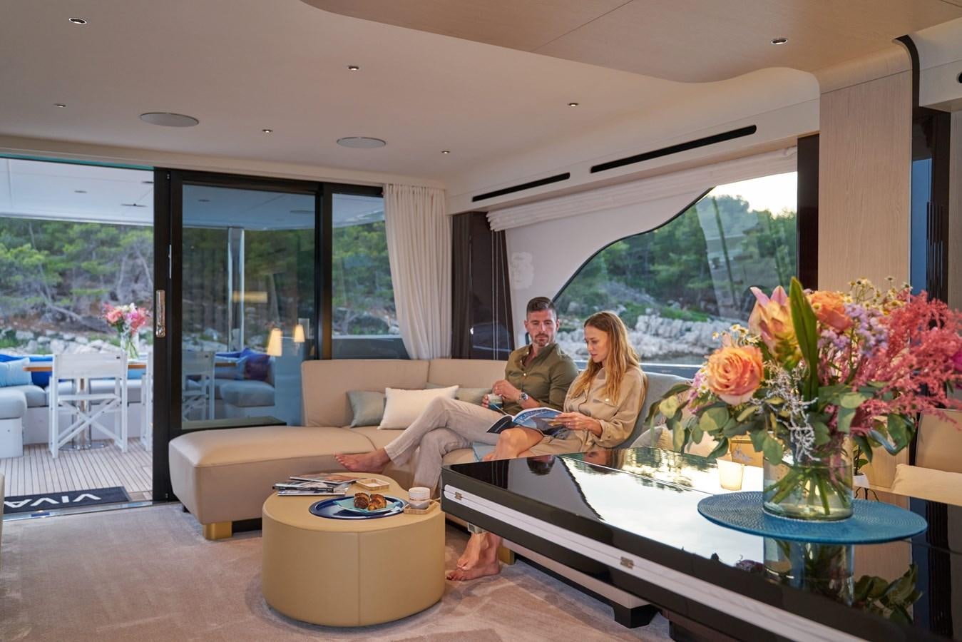 a family sitting in a living room aboard VIVA Yacht for Sale