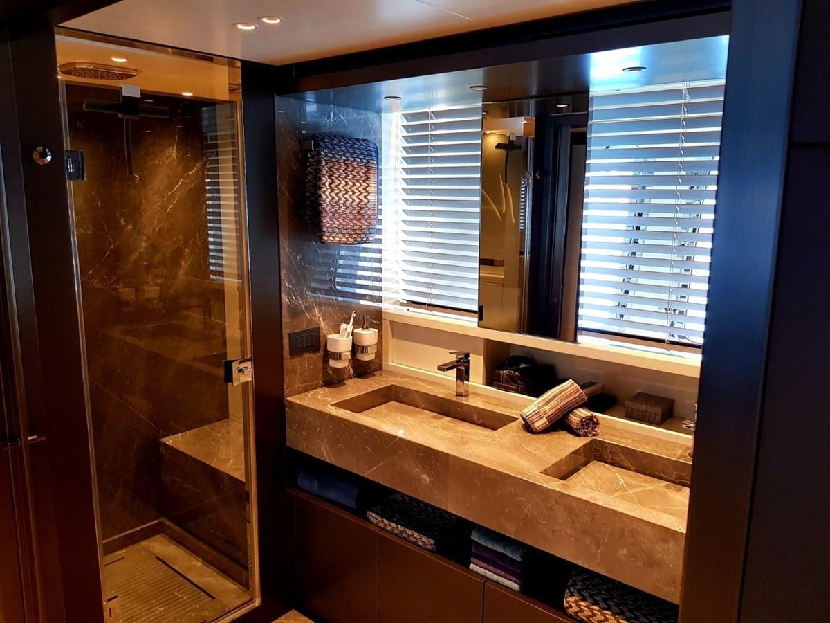 a bathroom with a countertop sink and a large mirror aboard 2020 SANLORENZO SX88 #43 Yacht for Sale