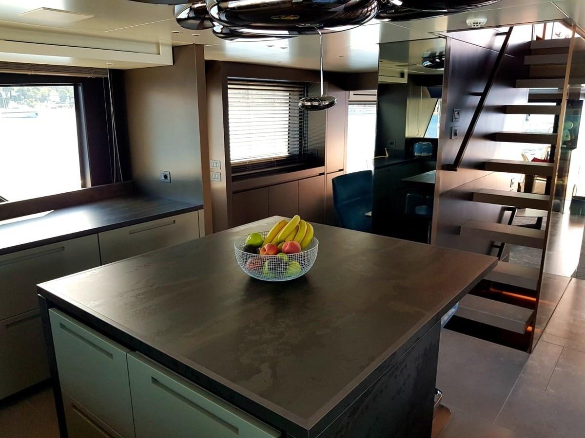 a kitchen with a bowl of fruit on a table aboard 2020 SANLORENZO SX88 #43 Yacht for Sale