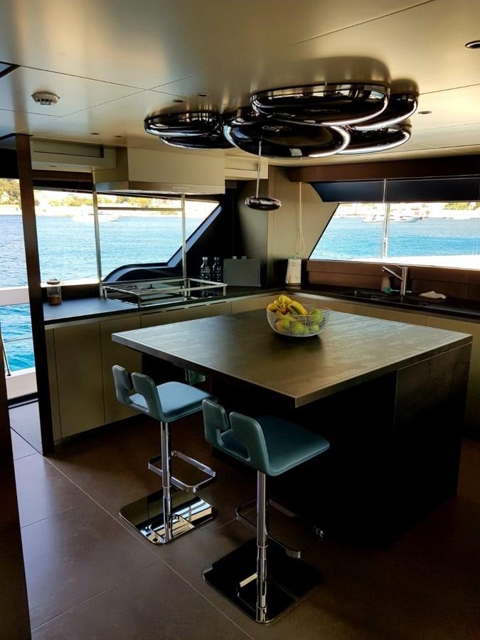 a kitchen with a bar and a table aboard 2020 SANLORENZO SX88 #43 Yacht for Sale