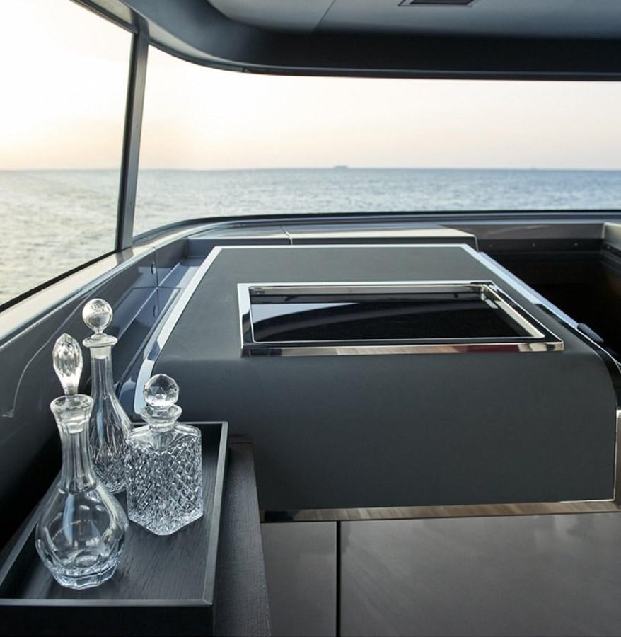 a table with a couple of glasses on it aboard 2022 SANLORENZO SX88 #47 Yacht for Sale