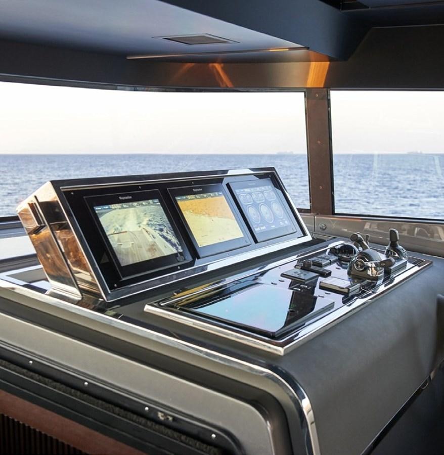 a kitchen with a stove and a laptop on it aboard 2022 SANLORENZO SX88 #47 Yacht for Sale