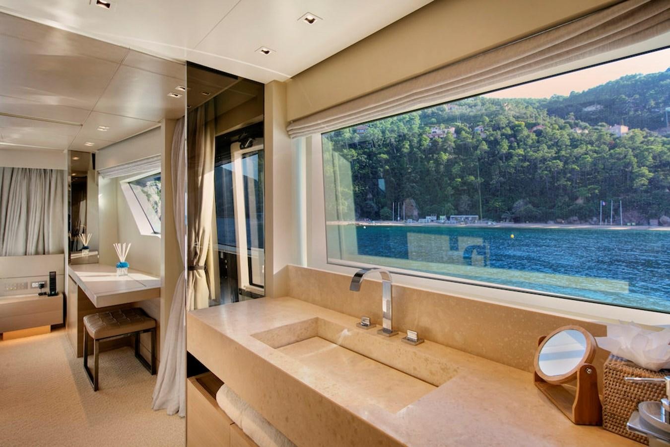 a bathroom with a large window overlooking a large pool aboard SX88 Yacht for Sale