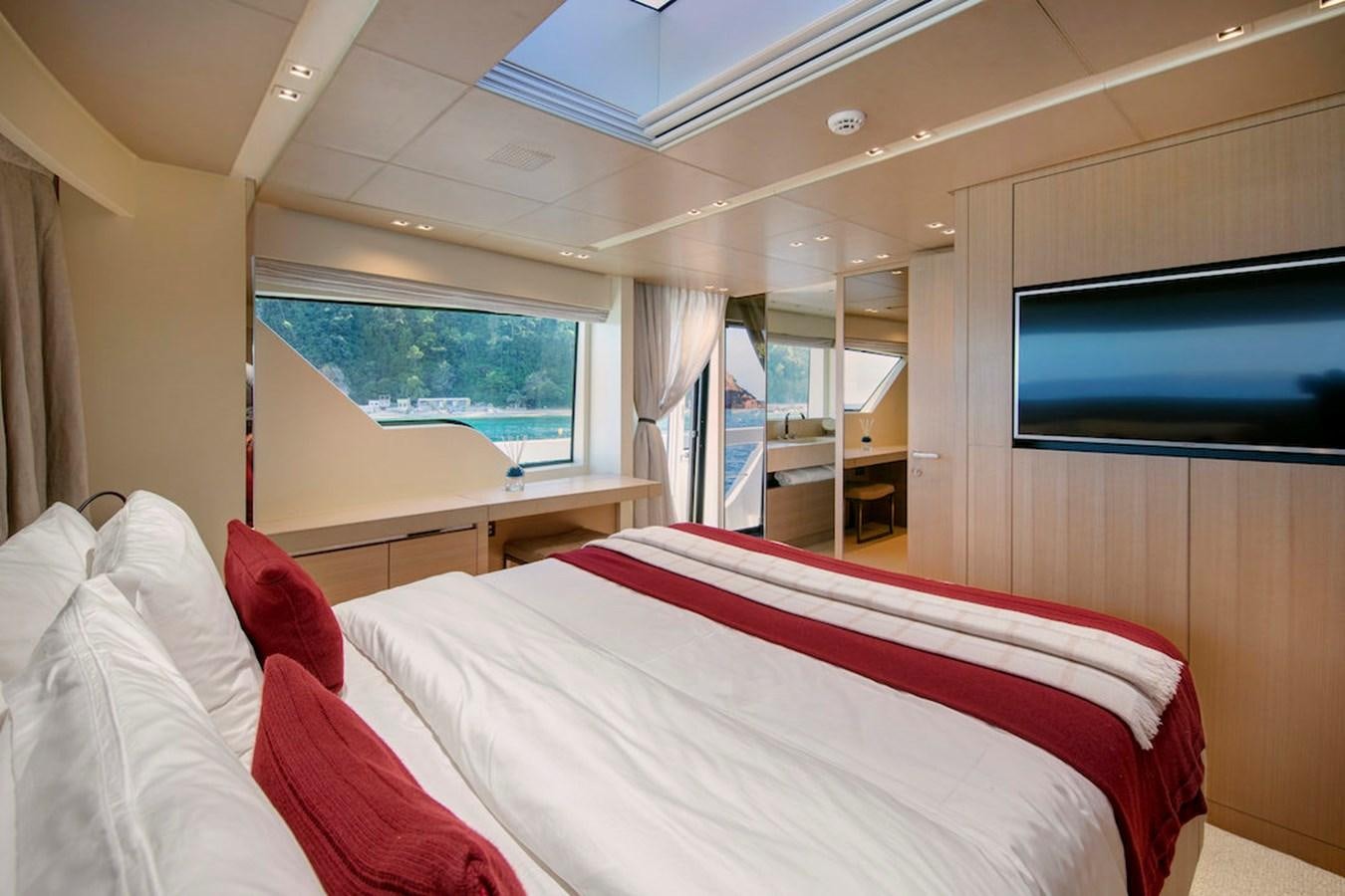 a room with a bed and a tv aboard SX88 Yacht for Sale