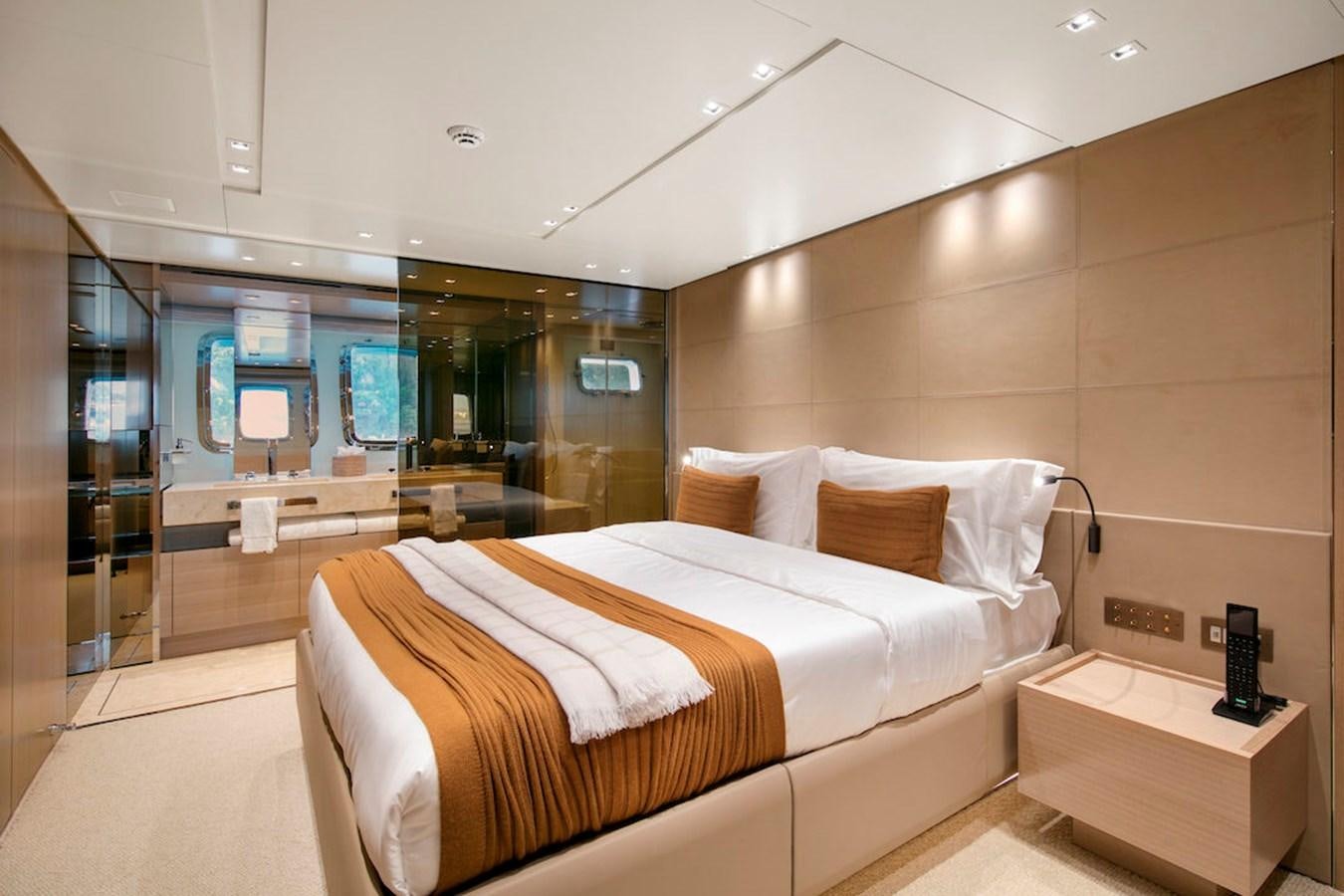 a room with a bed and a mirror aboard SX88 Yacht for Sale