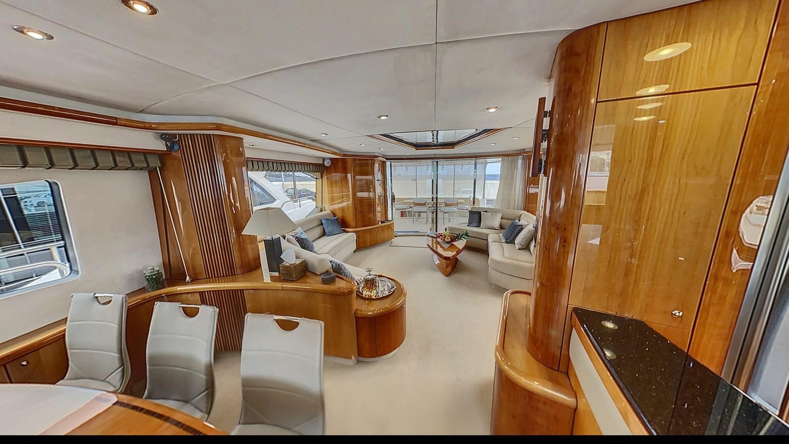 a room with a couch and a table and chairs aboard TOFUN Yacht for Sale
