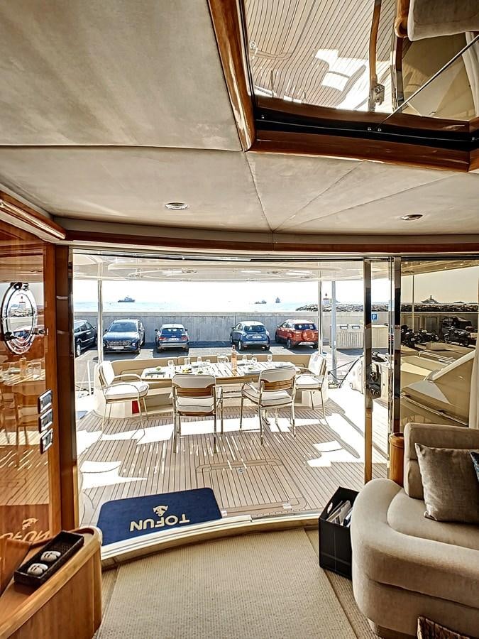 a bus with a table and chairs aboard TOFUN Yacht for Sale