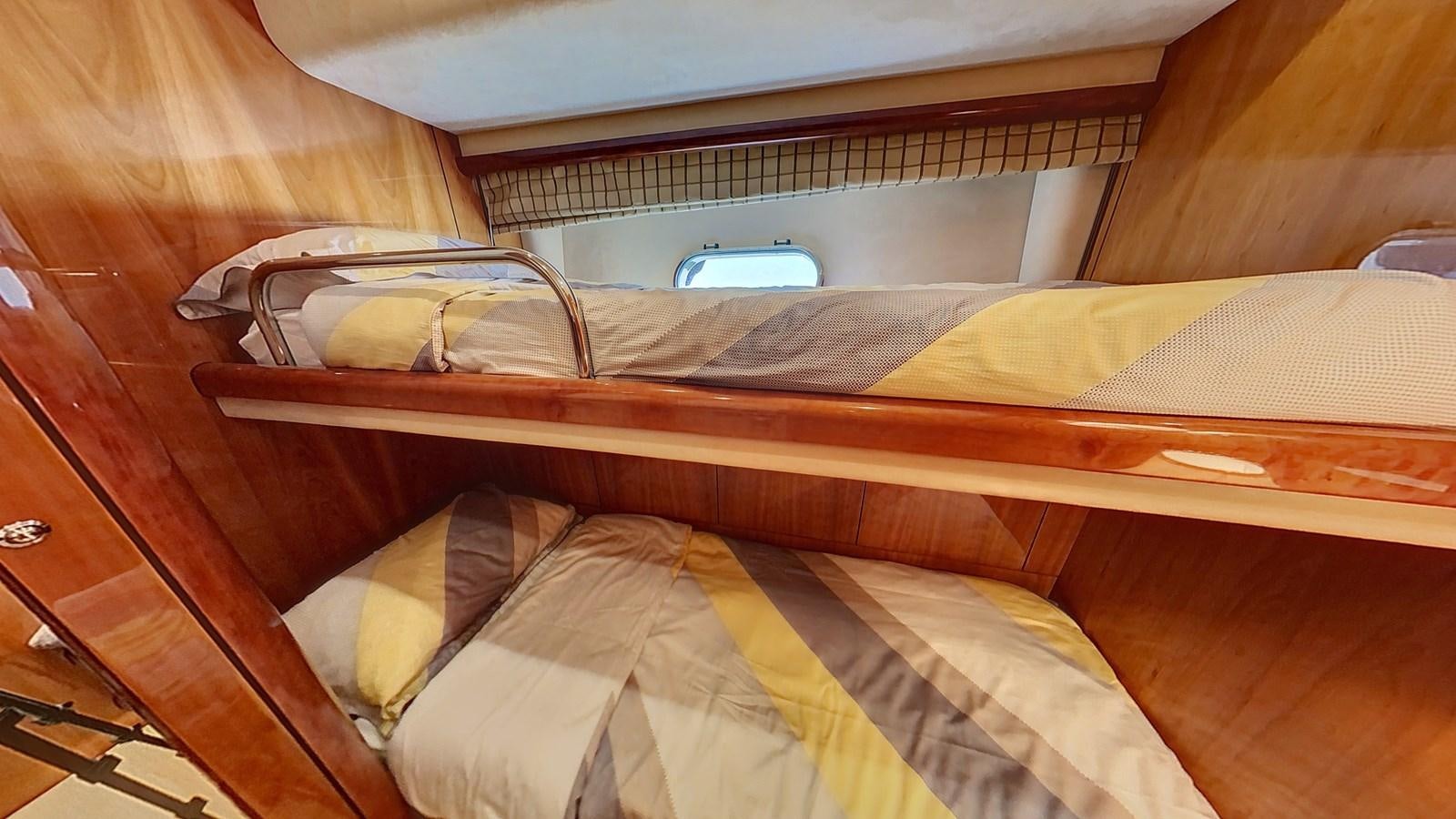 a bed with a wooden frame aboard TOFUN Yacht for Sale