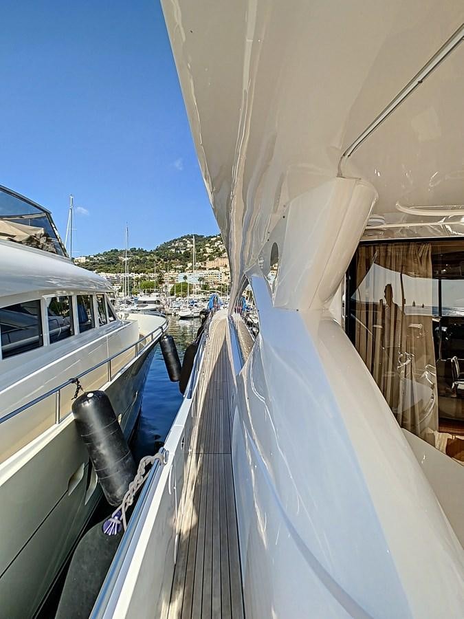 a boat is parked on the side of the water aboard TOFUN Yacht for Sale