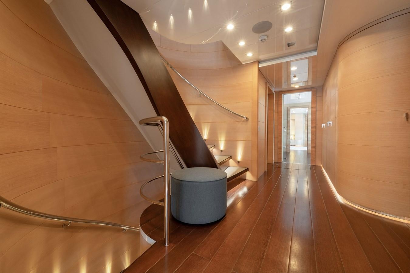 a room with a staircase and a wood floor aboard ZIA Yacht for Sale