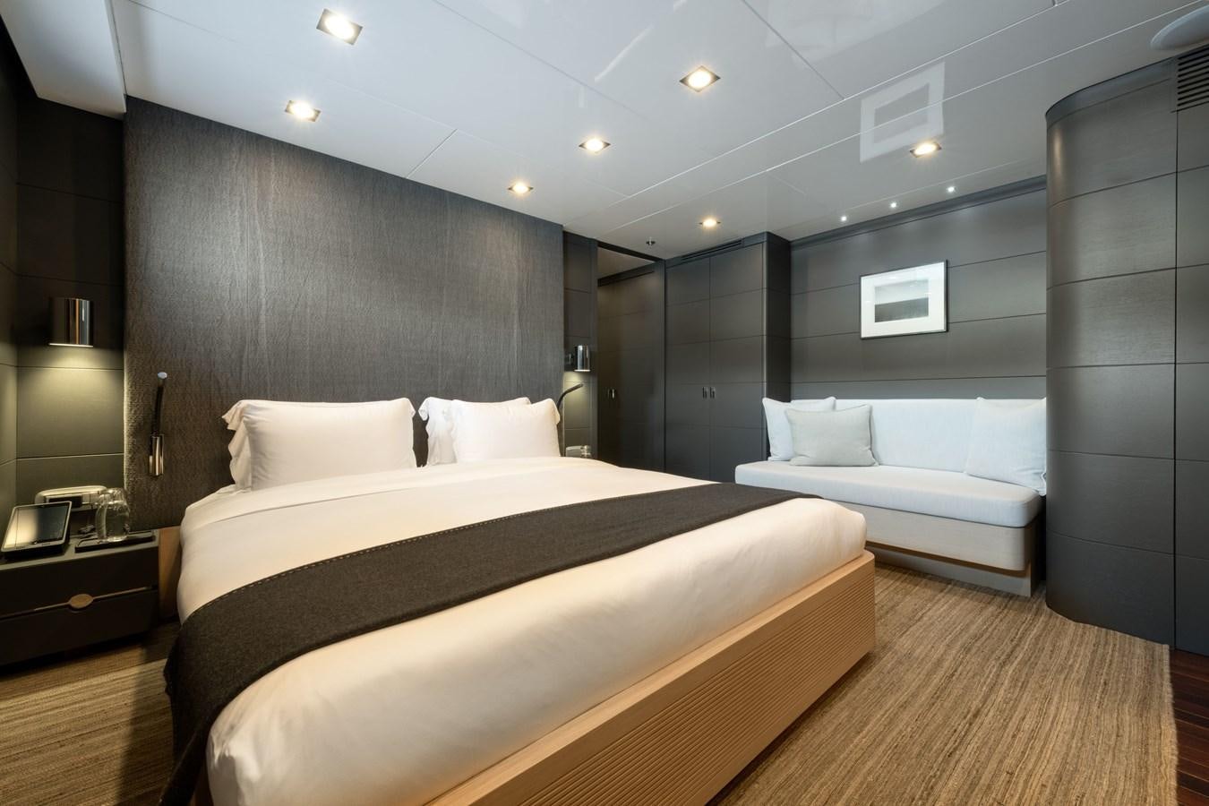 a room with a bed and a couch aboard ZIA Yacht for Sale