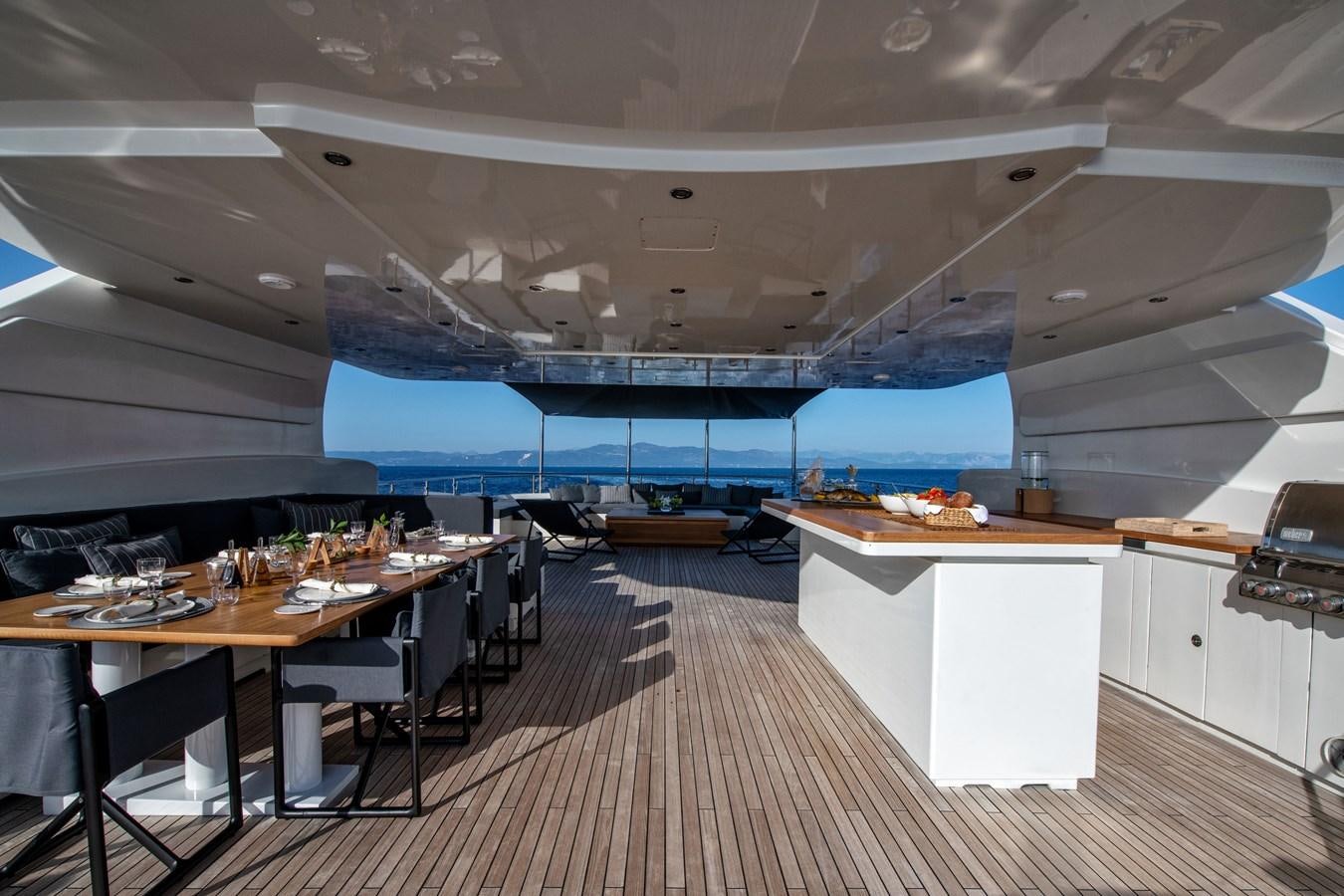 a room with tables and chairs aboard ZIA Yacht for Sale