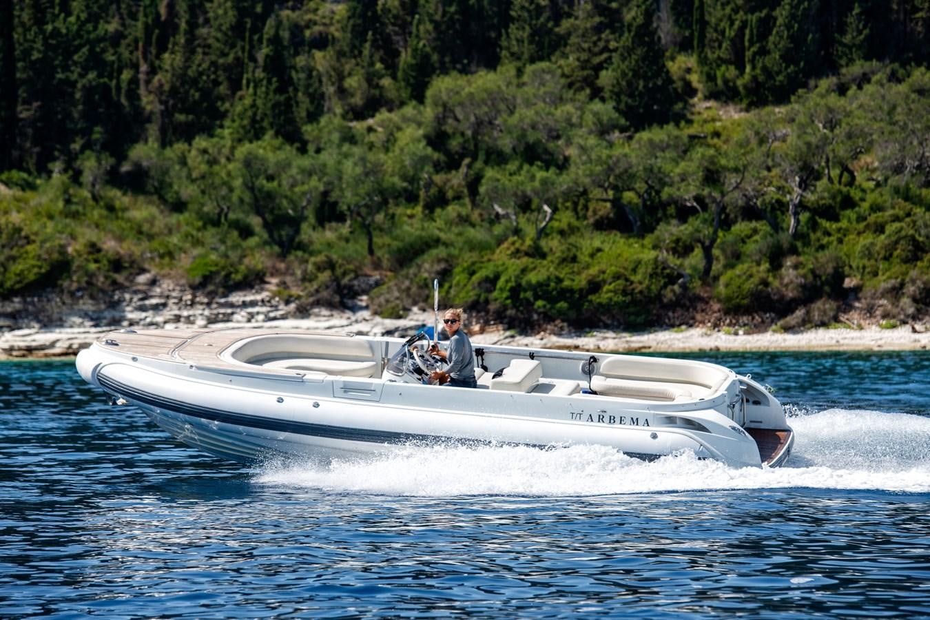a man driving a boat aboard ZIA Yacht for Sale