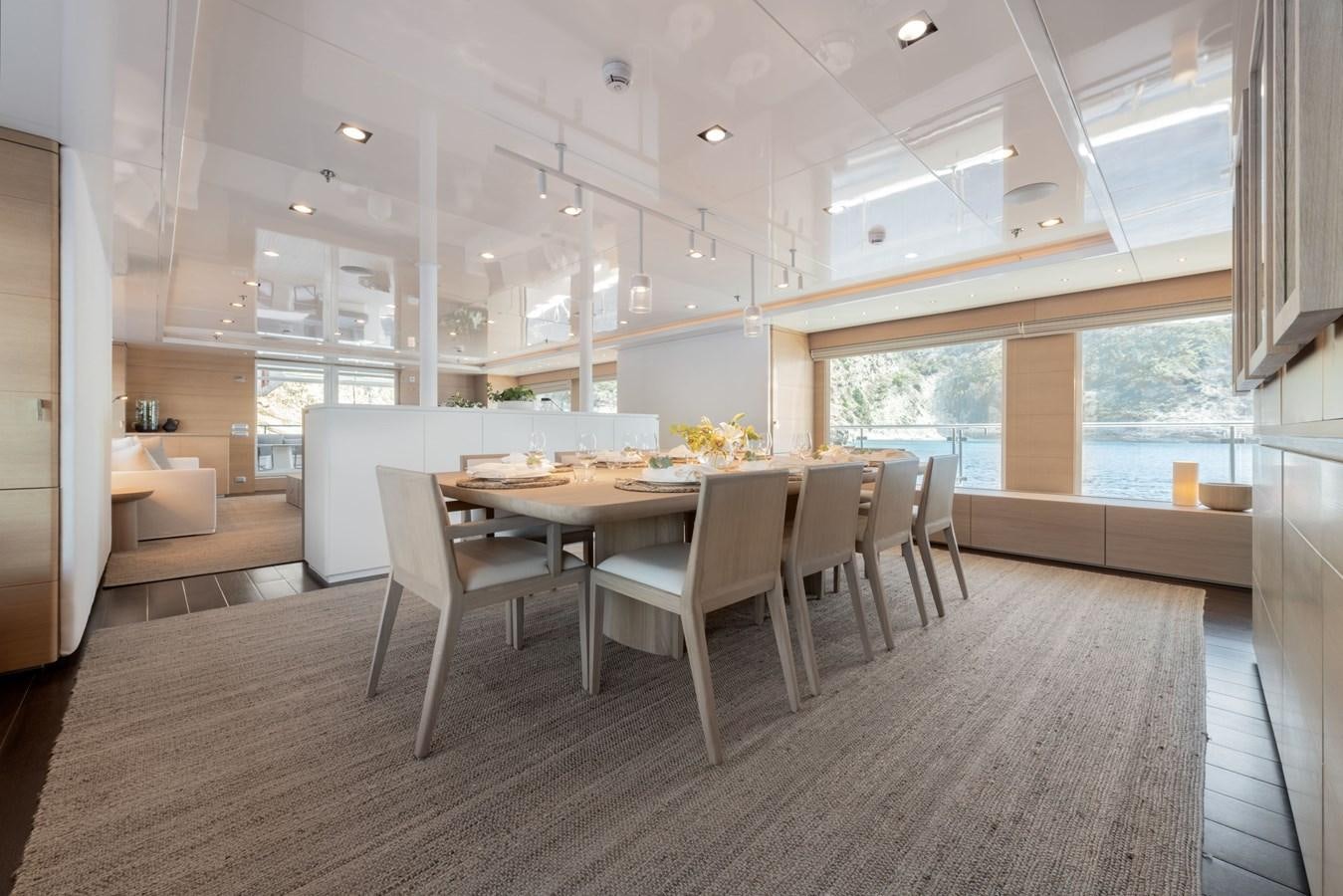 a large room with a table and chairs aboard ZIA Yacht for Sale