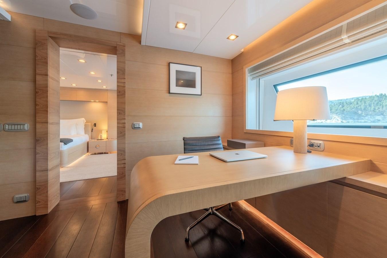 a room with a desk and a lamp aboard ZIA Yacht for Sale