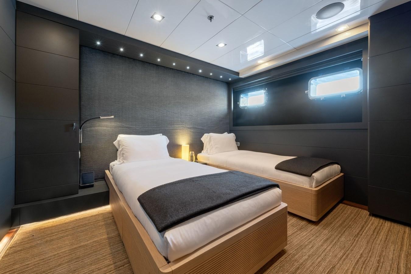 a room with a bed and a large mirror aboard ZIA Yacht for Sale