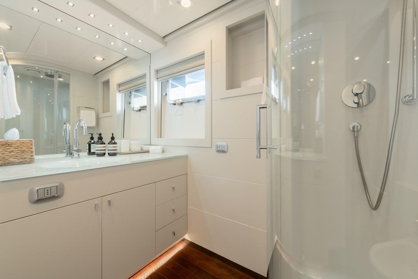 a bathroom with a large mirror aboard ZIA Yacht for Sale