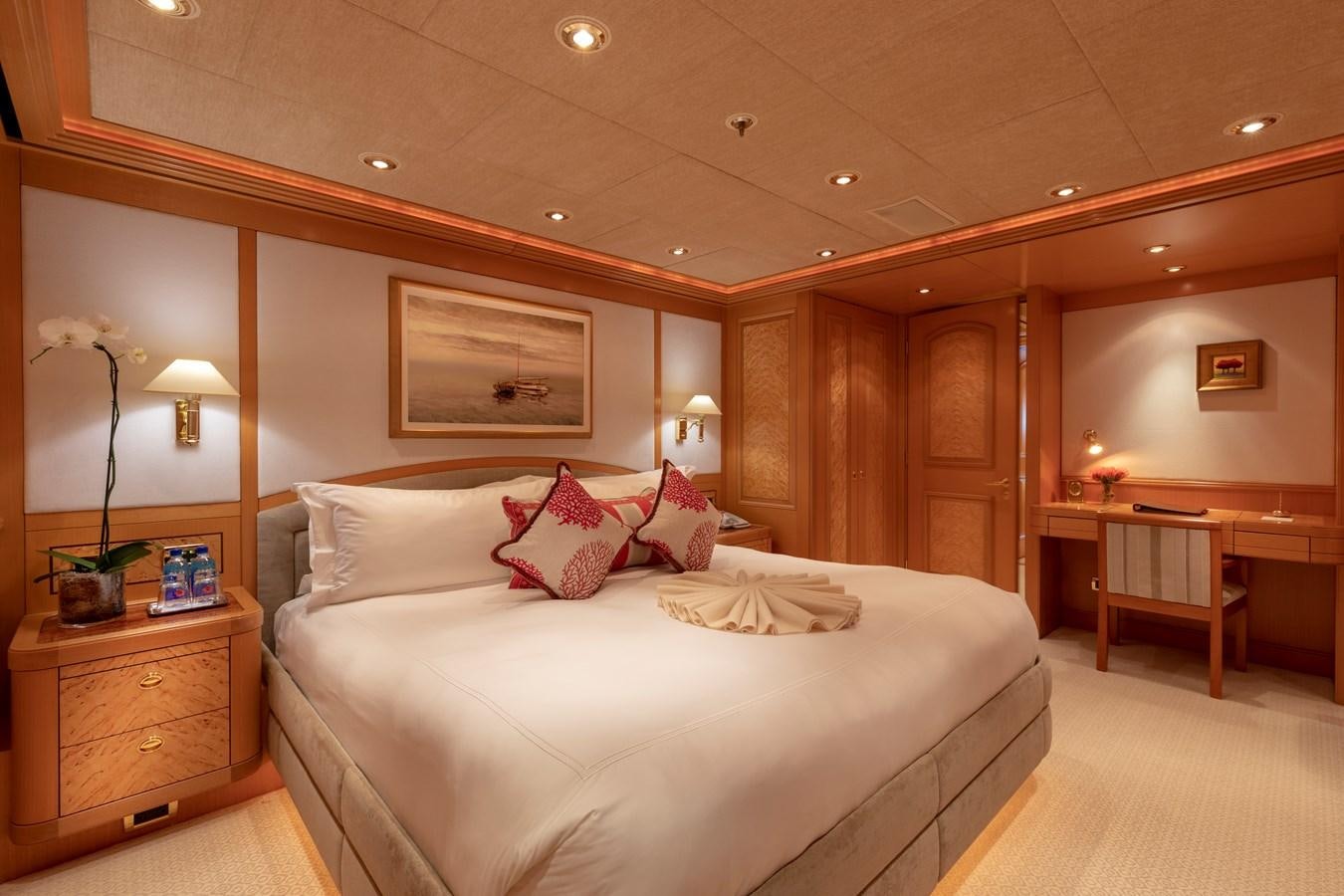 a bedroom with a bed and a desk aboard LAUREL Yacht for Sale