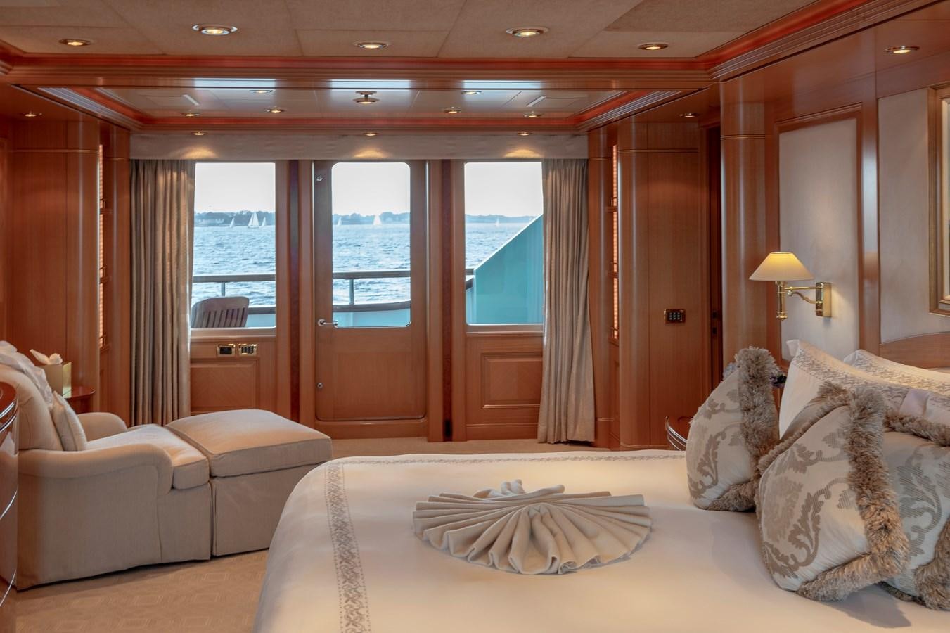 a hotel room with a bed and a large window aboard LAUREL Yacht for Sale