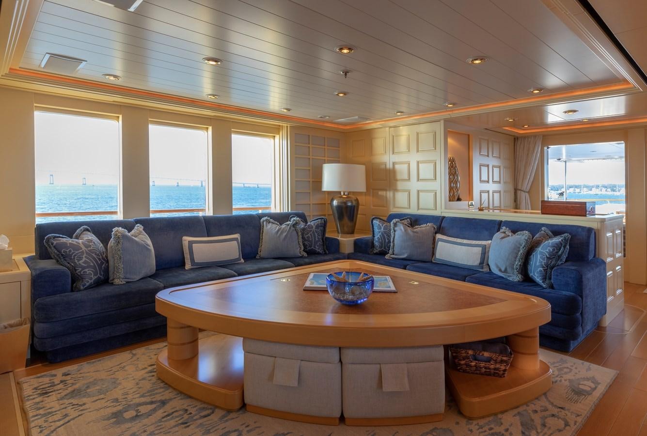 a living room with a large sectional sofa and a coffee table aboard LAUREL Yacht for Sale
