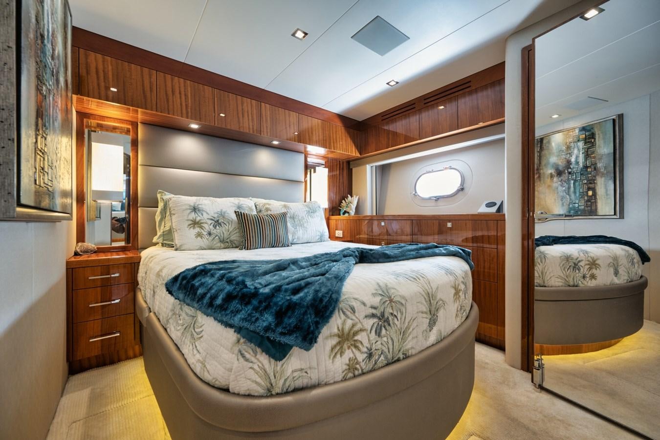 a bedroom with a bed and a mirror aboard DONE DEAL Yacht for Sale