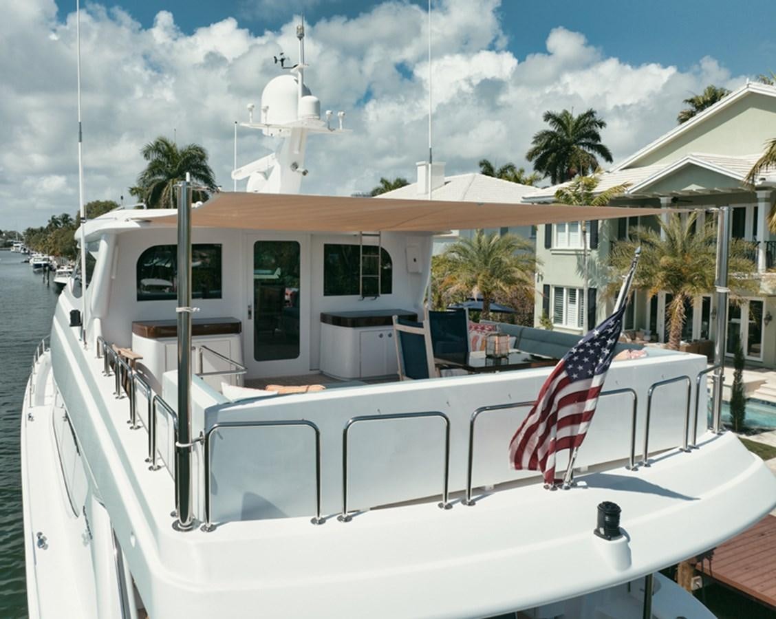 a deck with a flag and a flag on it aboard DONE DEAL Yacht for Sale