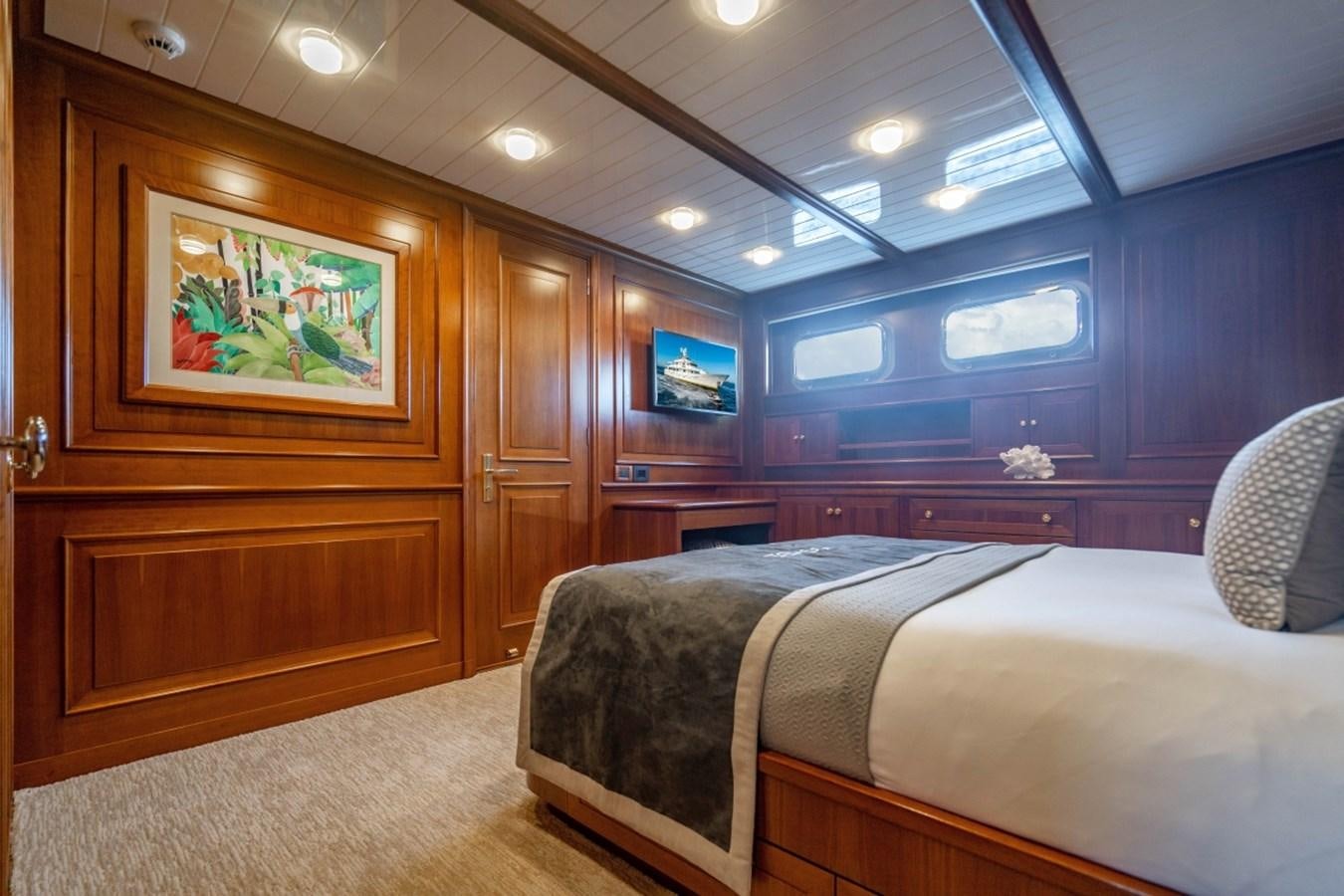a room with a bed and a television aboard DRAMA QUEEN Yacht for Sale