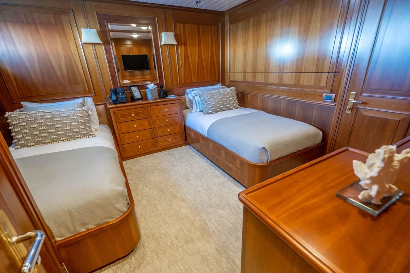 a room with a bed and a table aboard DRAMA QUEEN Yacht for Sale