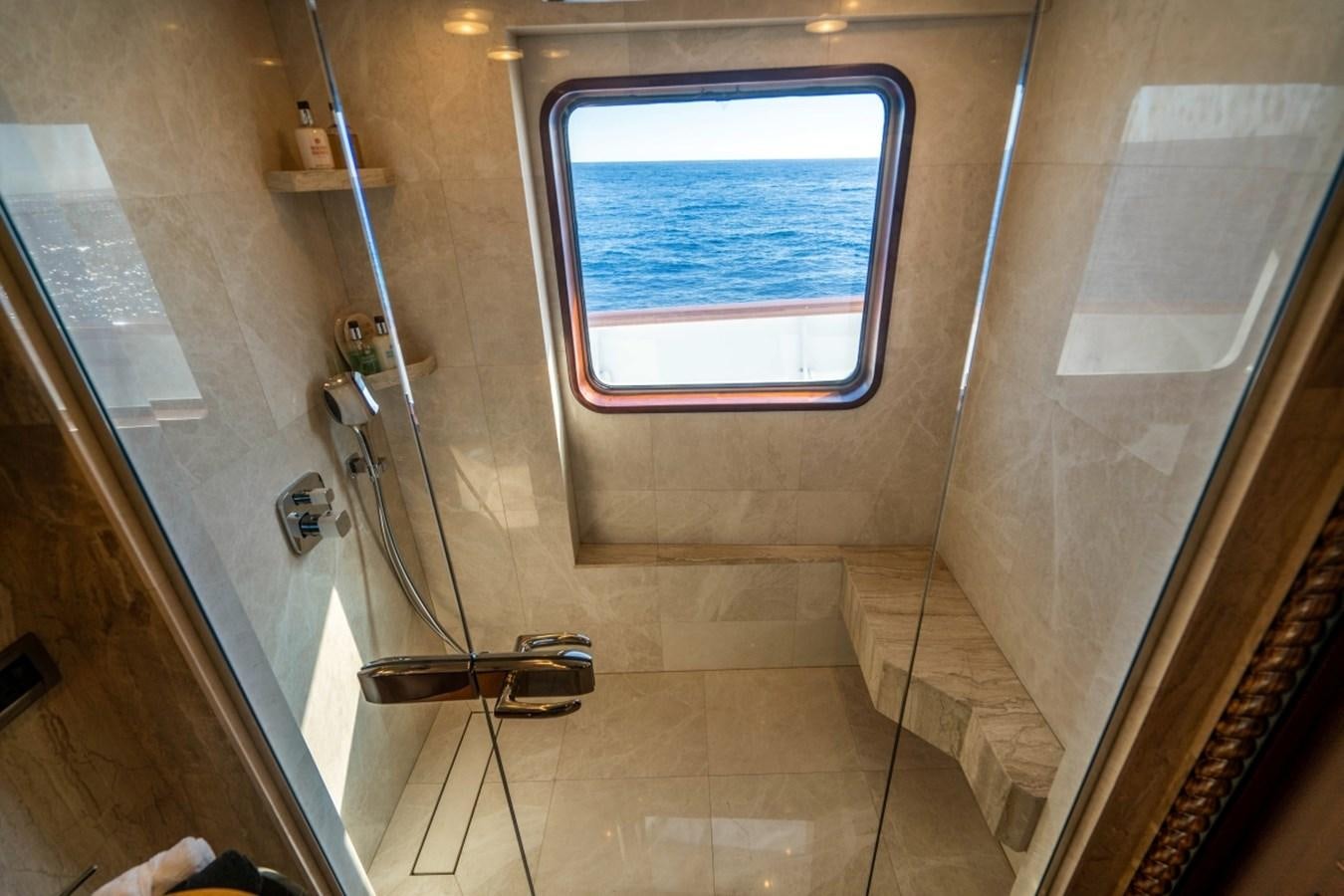 a bathroom with a glass shower aboard DRAMA QUEEN Yacht for Sale