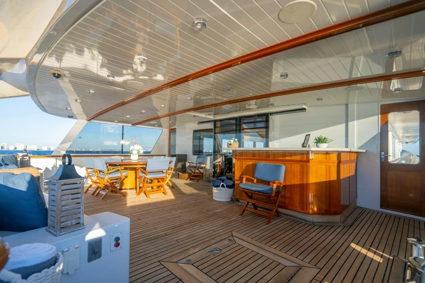 a room with a table chairs and a large window aboard DRAMA QUEEN Yacht for Sale