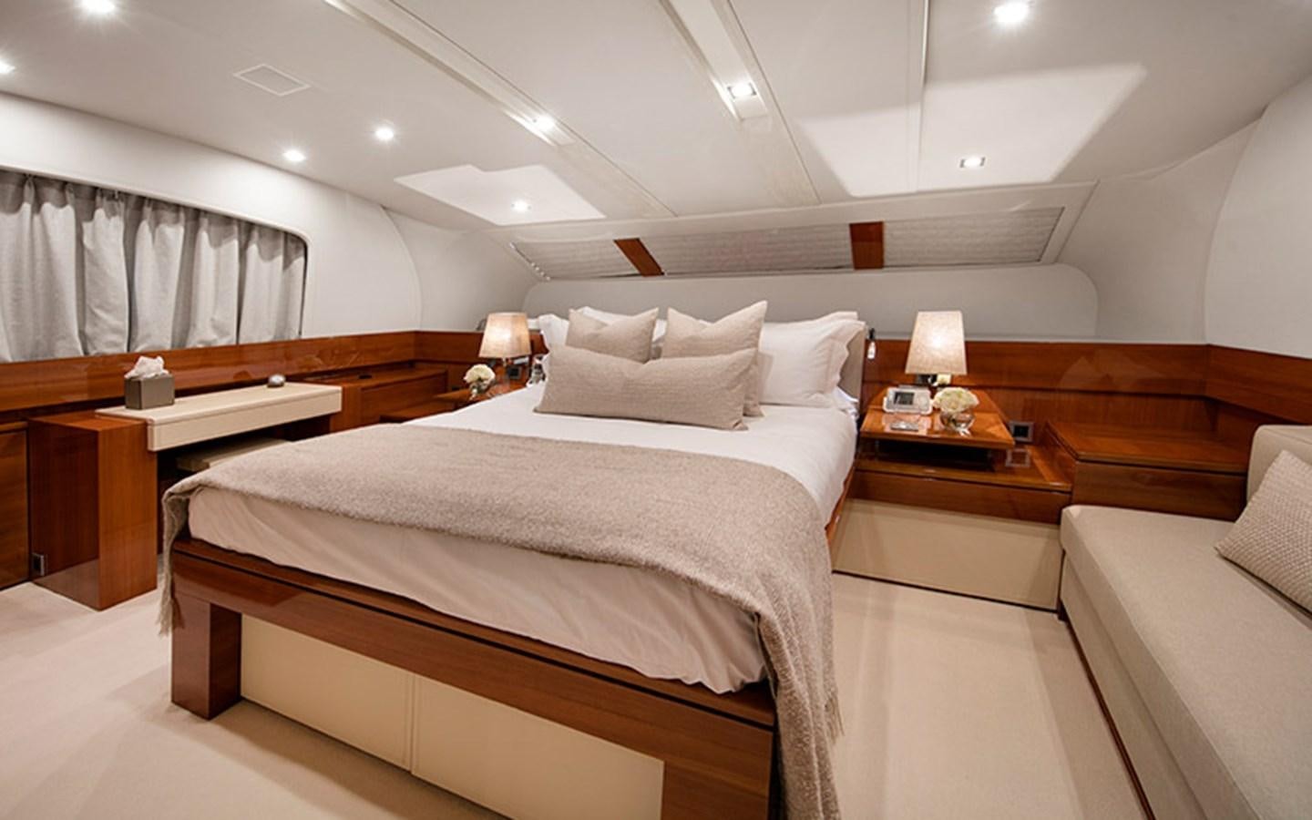 a room with a bed and a desk aboard NYOTA Yacht for Charter
