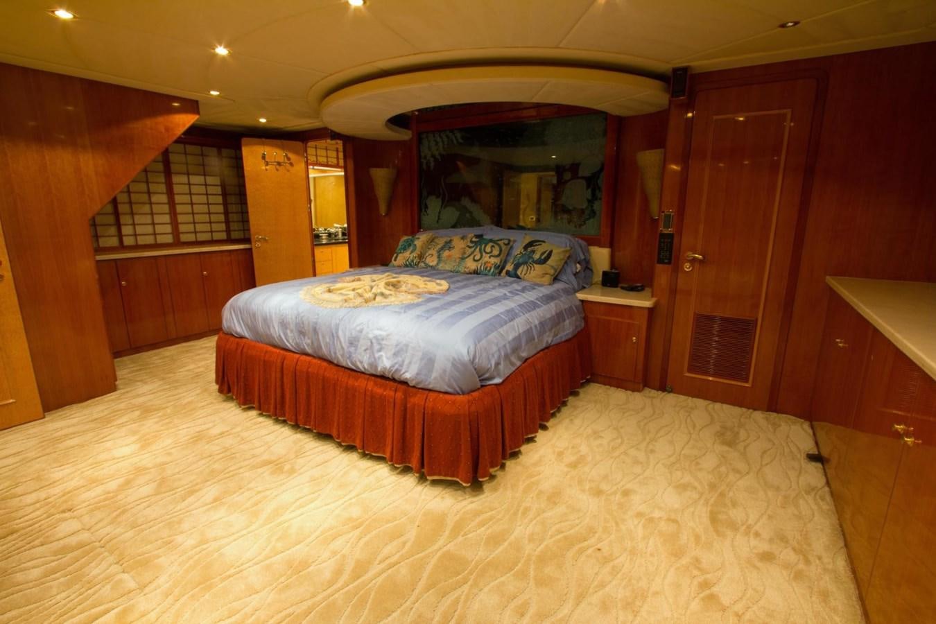 a bedroom with a bed and a wood door aboard GLEN ELLEN Yacht for Sale