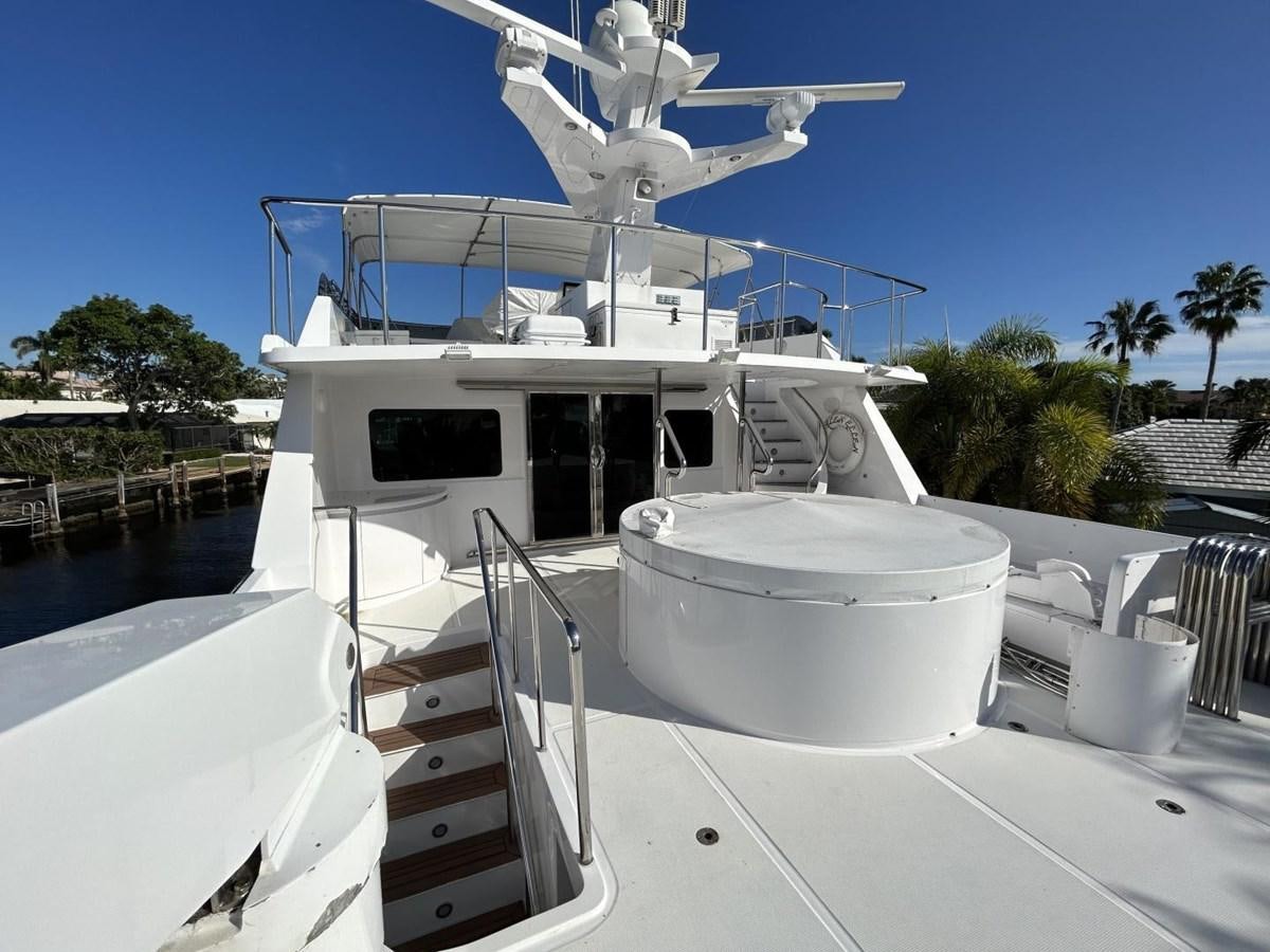 a white boat on a deck aboard GLEN ELLEN Yacht for Sale