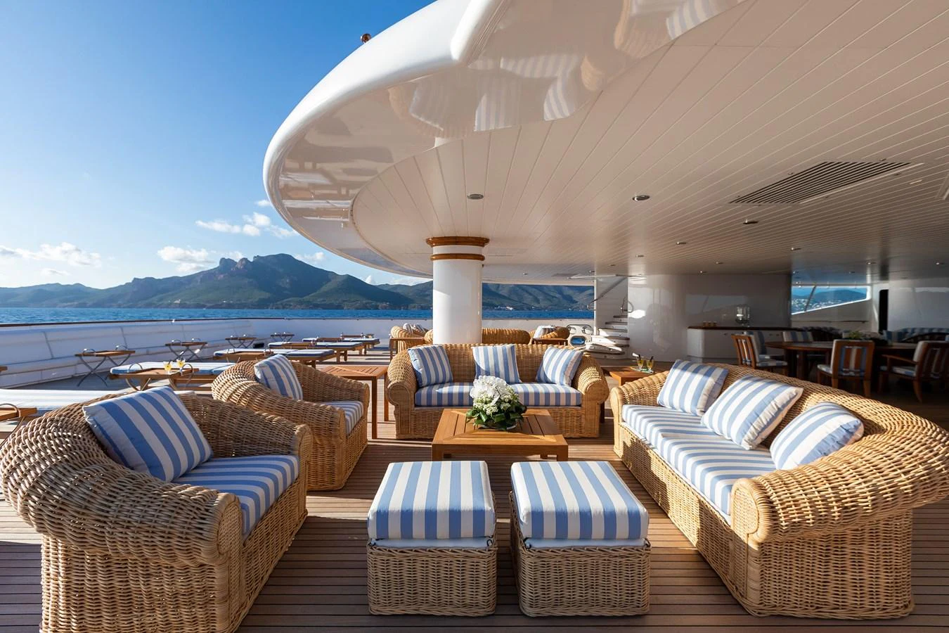 a large lounge area with a large white umbrella over it aboard CARINTHIA VII Yacht for Charter