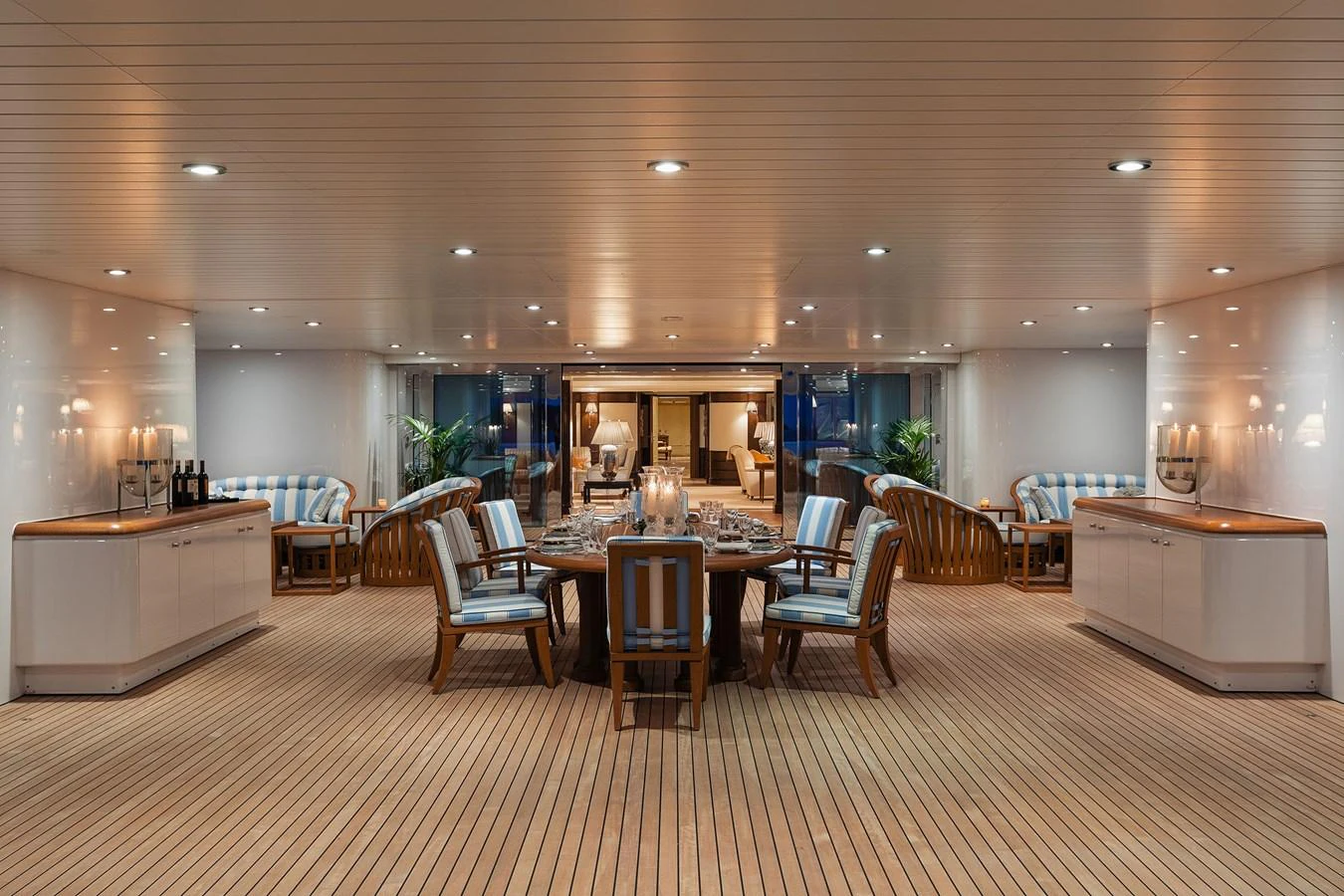 a large room with a table and chairs aboard CARINTHIA VII Yacht for Charter