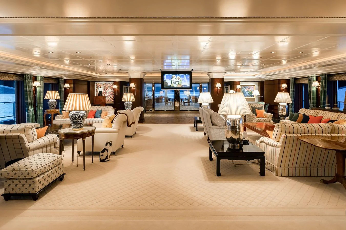 a living room with a large screen aboard CARINTHIA VII Yacht for Charter