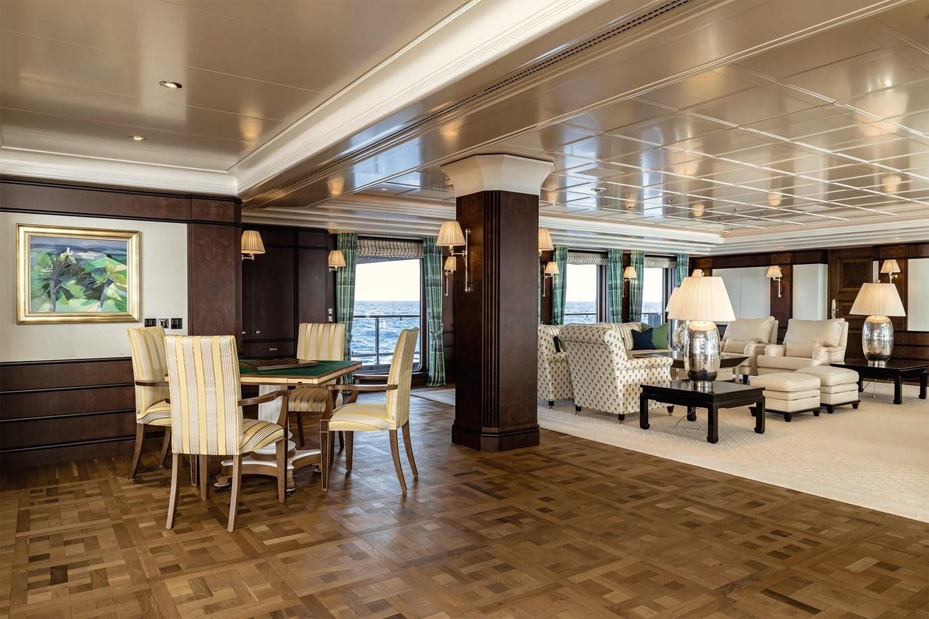 a large living room with a large wood floor aboard CARINTHIA VII Yacht for Sale
