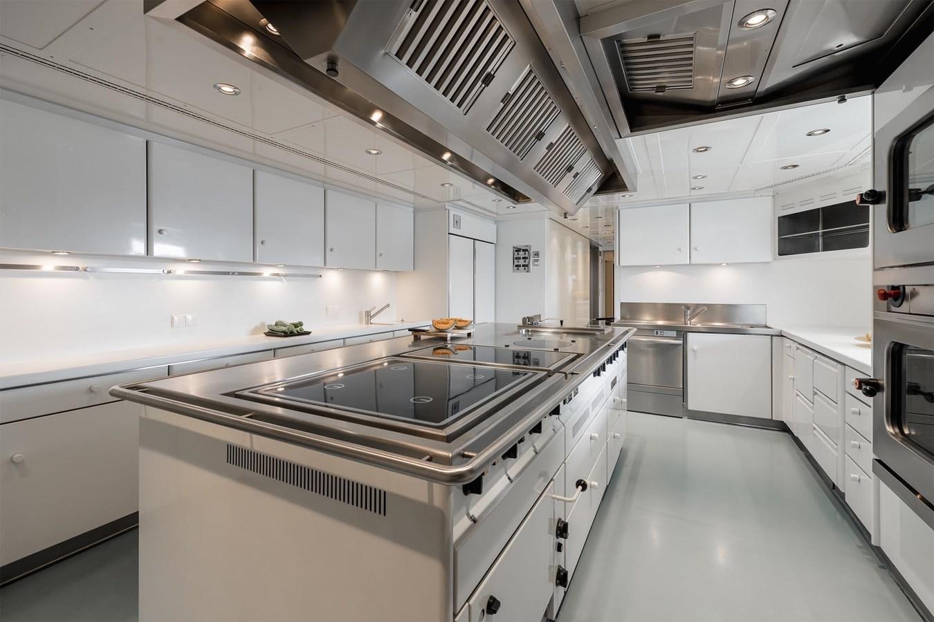 a kitchen with white cabinets aboard CARINTHIA VII Yacht for Sale