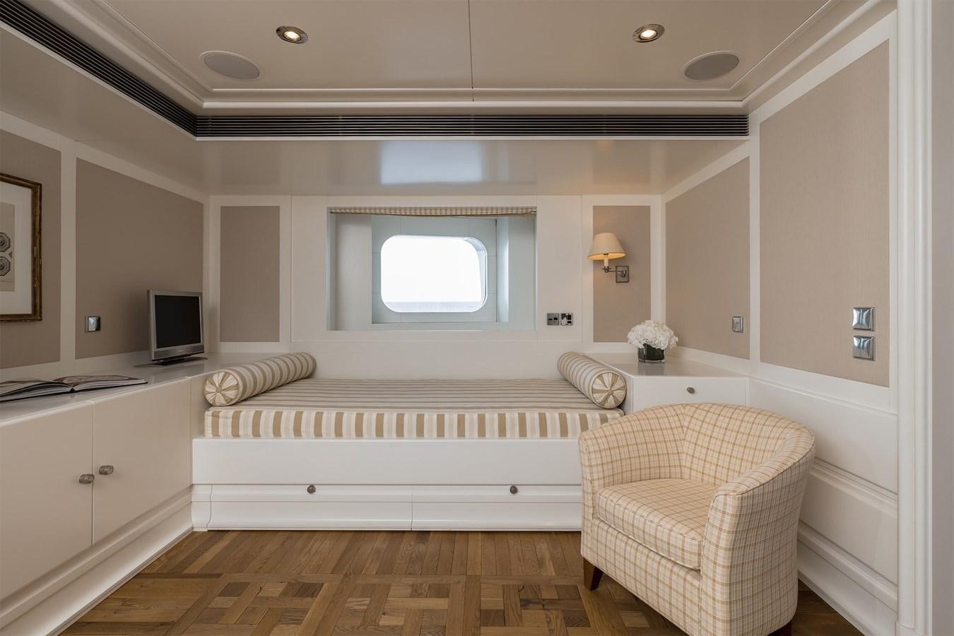 a white living room with a large window aboard CARINTHIA VII Yacht for Sale