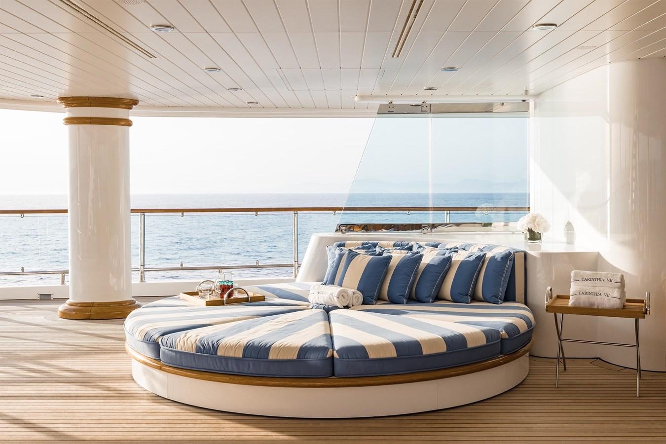 a bed with a blue and white bed spread aboard CARINTHIA VII Yacht for Sale