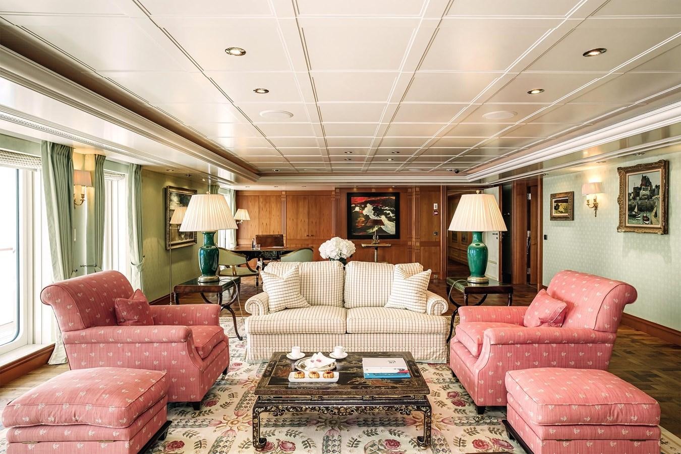 a living room with a couch and a coffee table aboard CARINTHIA VII Yacht for Sale