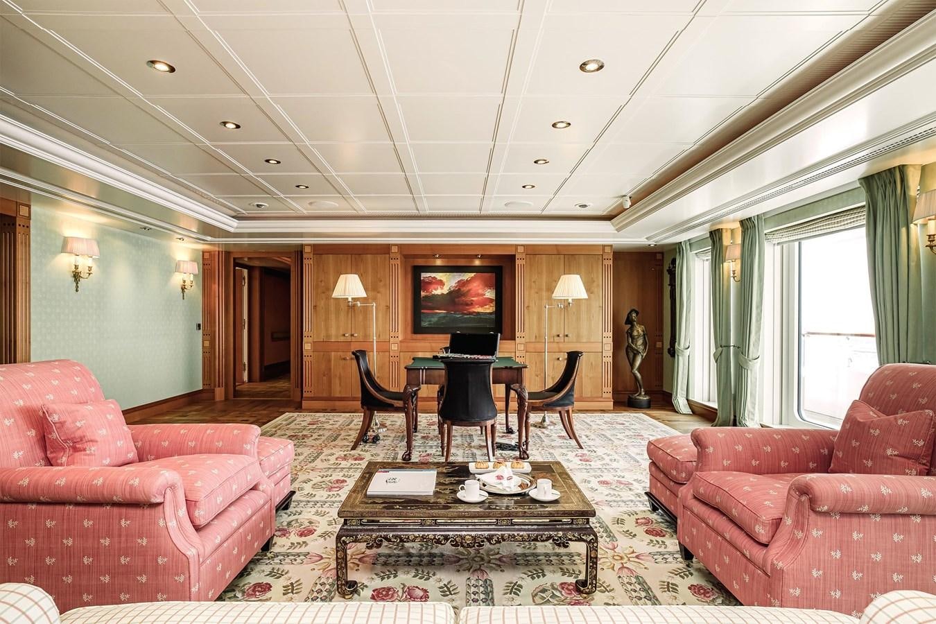 a living room with a table and chairs aboard CARINTHIA VII Yacht for Sale