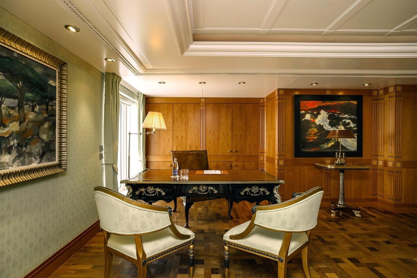 a room with a table and chairs aboard CARINTHIA VII Yacht for Sale